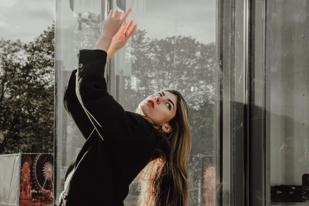 Model in Wool Black Coat Leaning Back