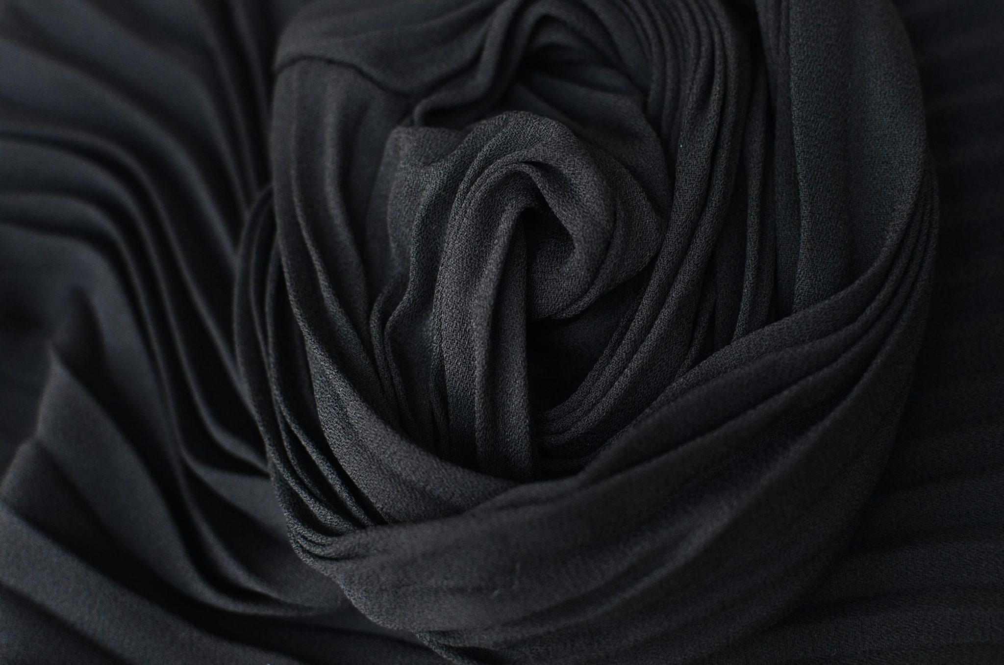 Top view abstract textured background of dark gray pleated textile placed on table